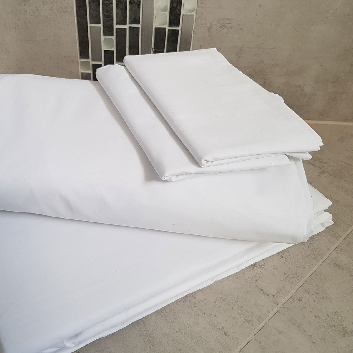 White Bed Sheet Set on Marble Tile